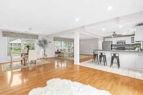 a dining room with furniture and wooden floor