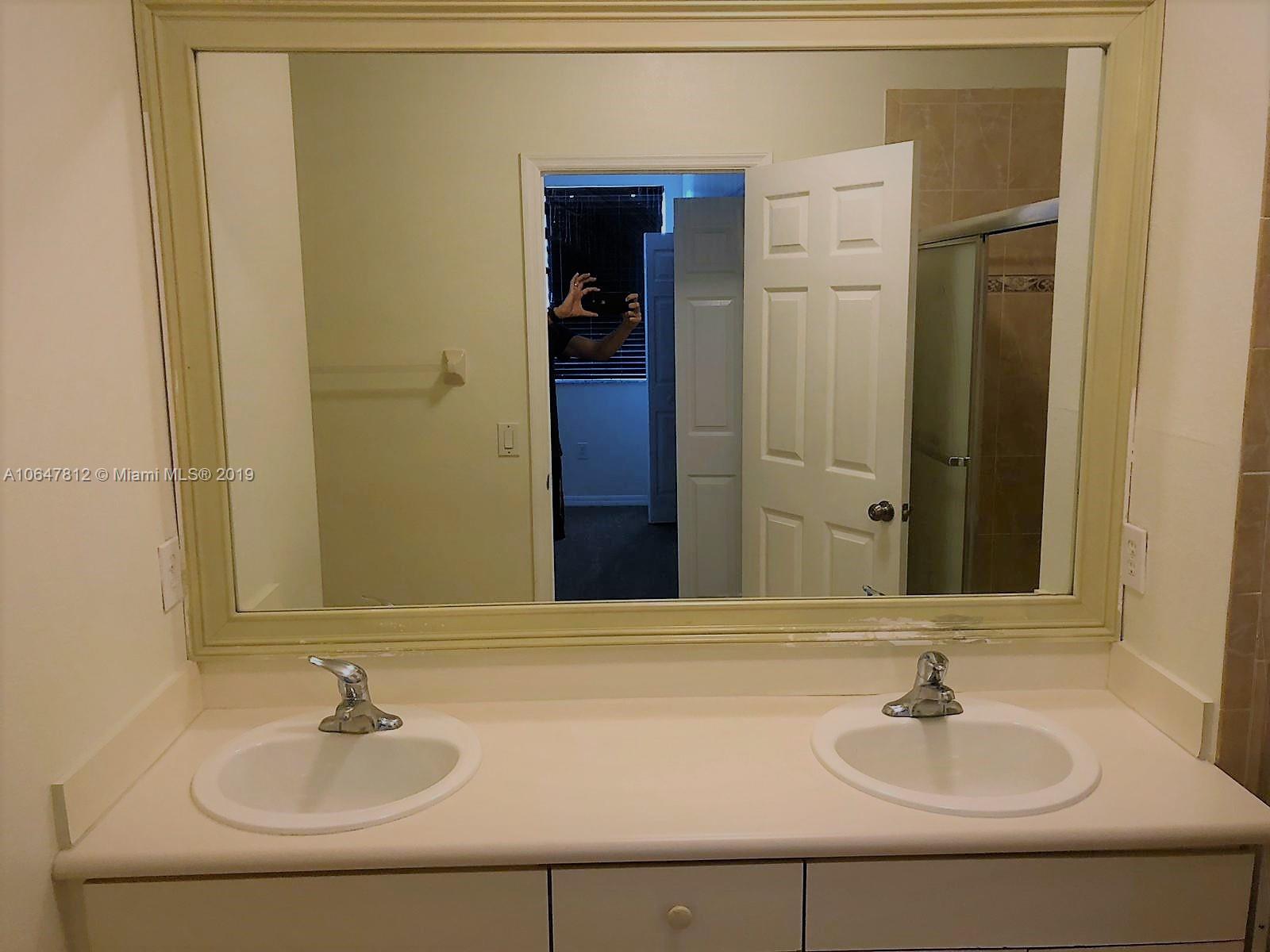 27293 Southwest 138th Path Homestead, FL 33032 - Photo 11 of 19 a bathroom with a sink and a mirror