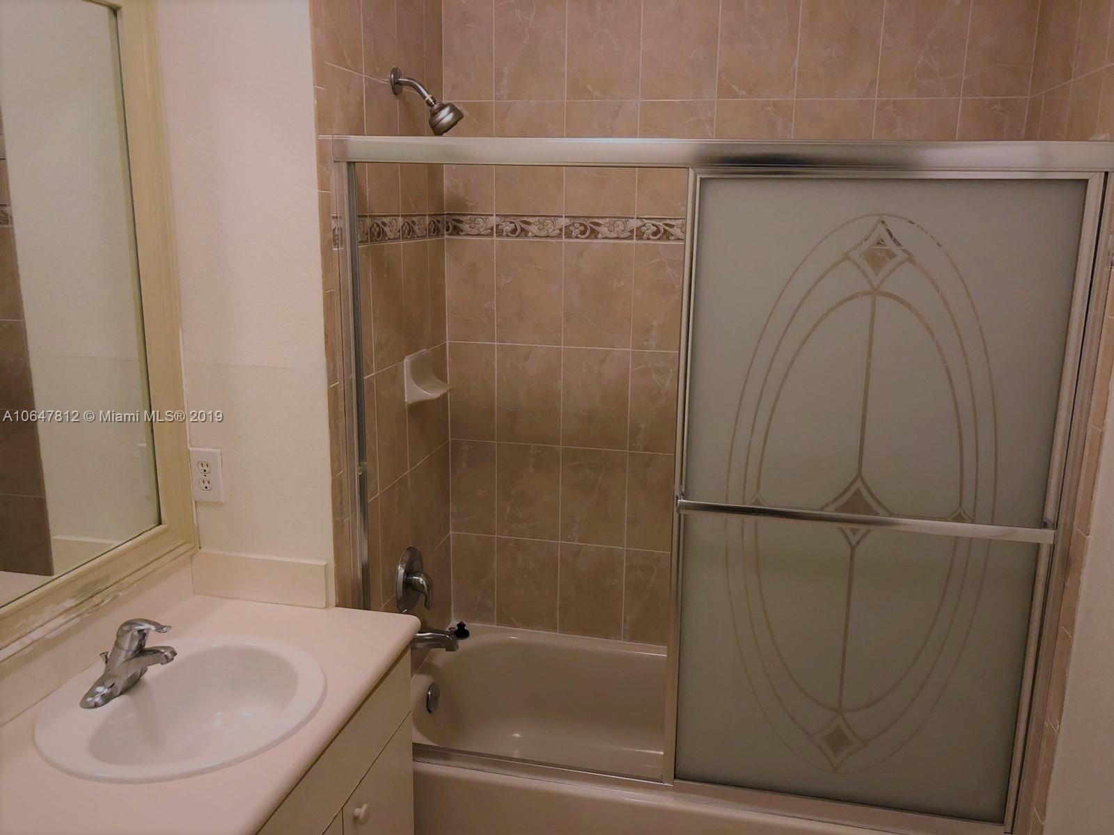 27293 Southwest 138th Path Homestead, FL 33032 - Photo 13 of 19 a bathroom with a sink and a shower