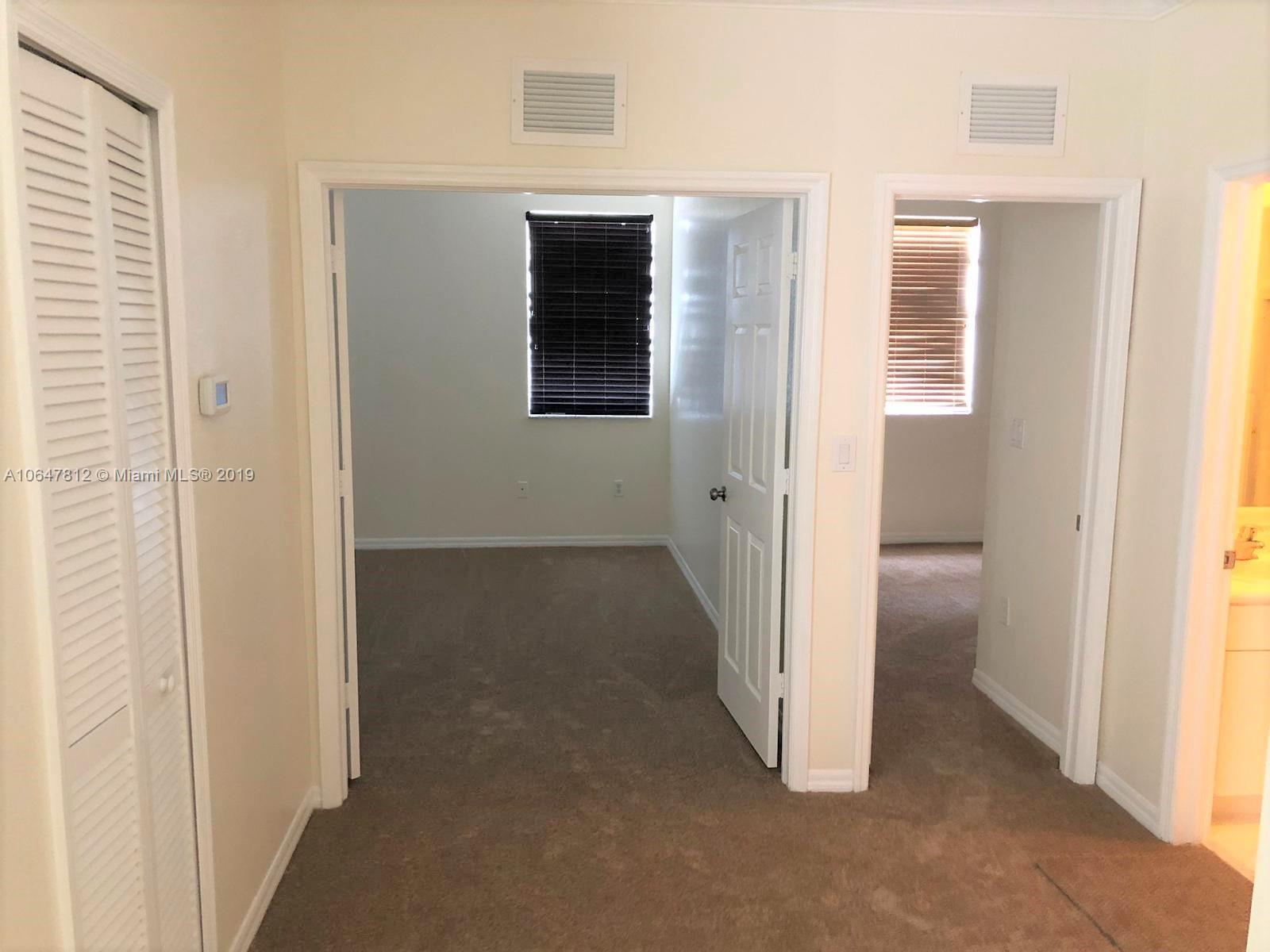 27293 Southwest 138th Path Homestead, FL 33032 - Photo 14 of 19 a view of a room with a hallway