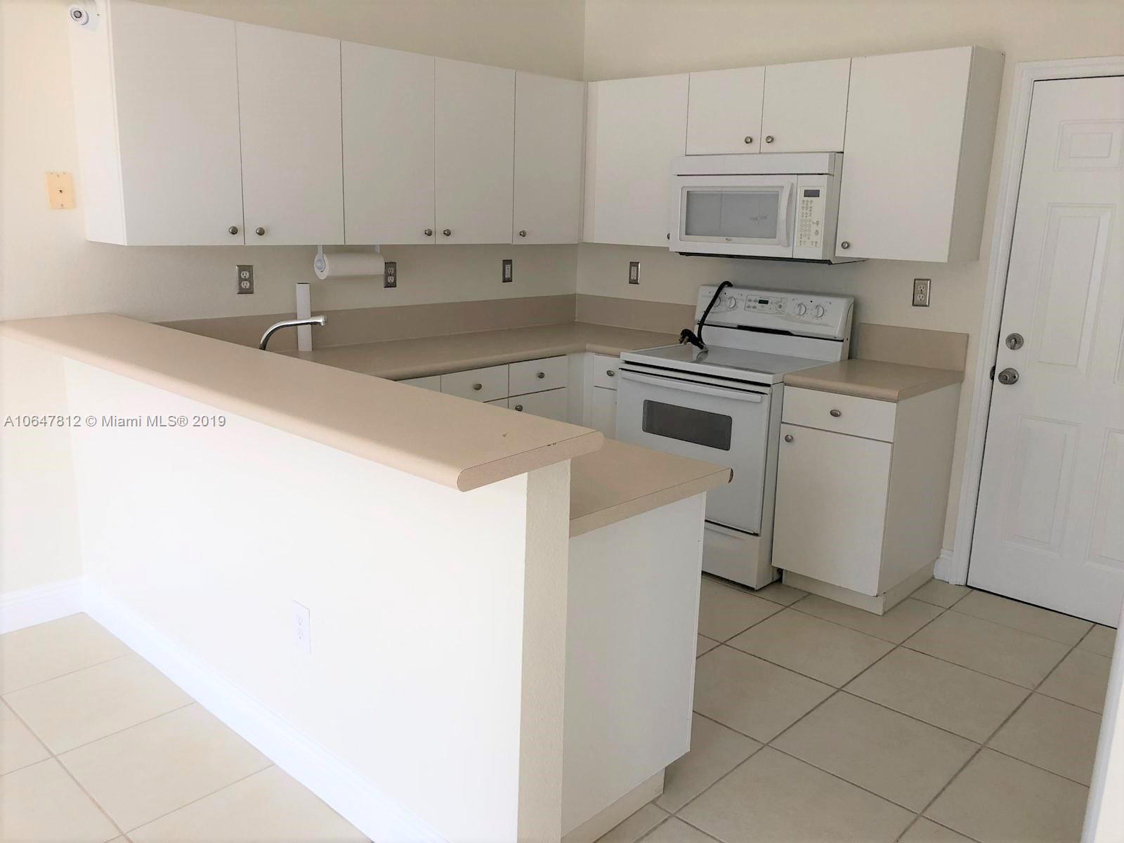 27293 Southwest 138th Path Homestead, FL 33032 - Photo 4 of 19 a kitchen with white cabinets and sink