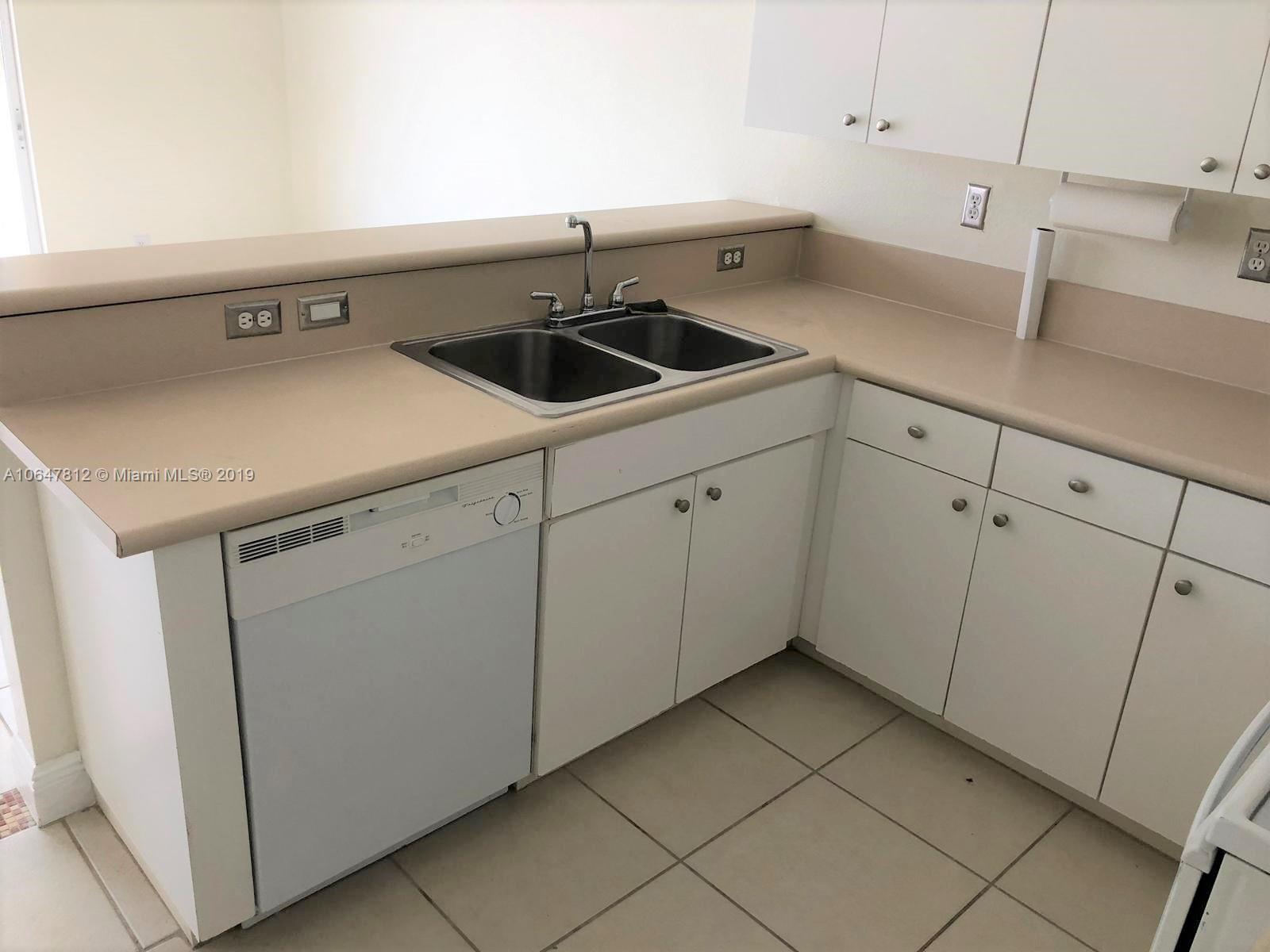 27293 Southwest 138th Path Homestead, FL 33032 - Photo 5 of 19 a kitchen with a sink and cabinets