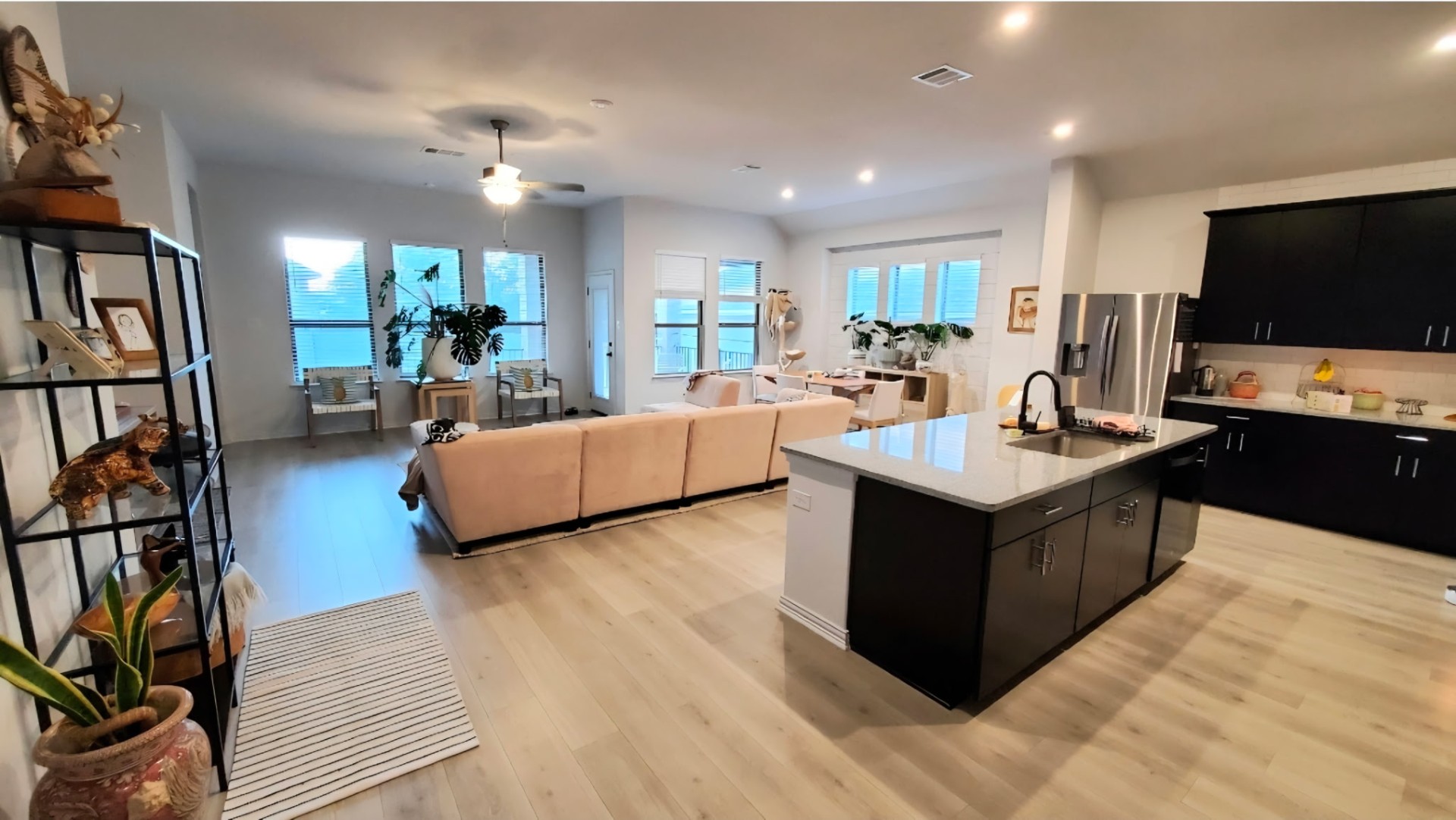 3833 Mercer Road Georgetown, TX 78628 - Photo 16 of 25 Bright, open-concept living area with a contemporary kitchen and light hardwood floors throughout.