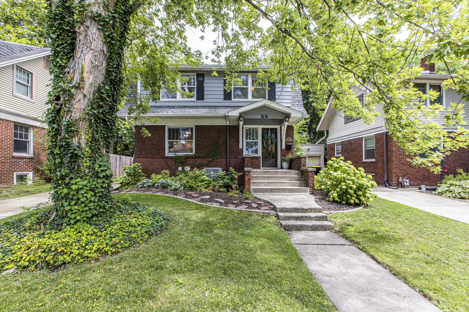 a front view of a house with a garden