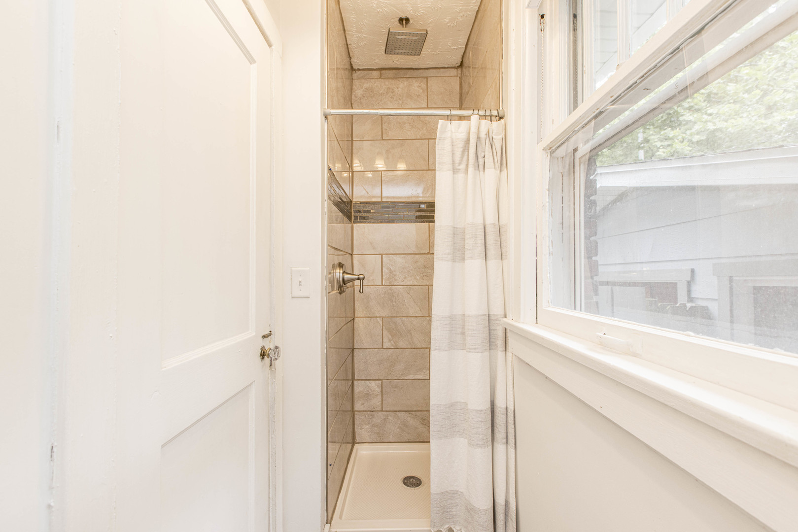 22 Broadway Place Normal, IL 61761 - Photo 12 of 36 a bathroom with a glass shower door and a large window