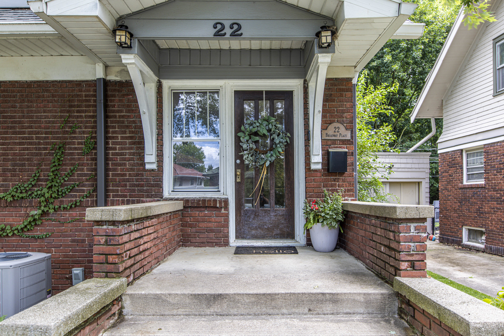 22 Broadway Place Normal, IL 61761 - Photo 35 of 36 a view of front door of house with potted plants