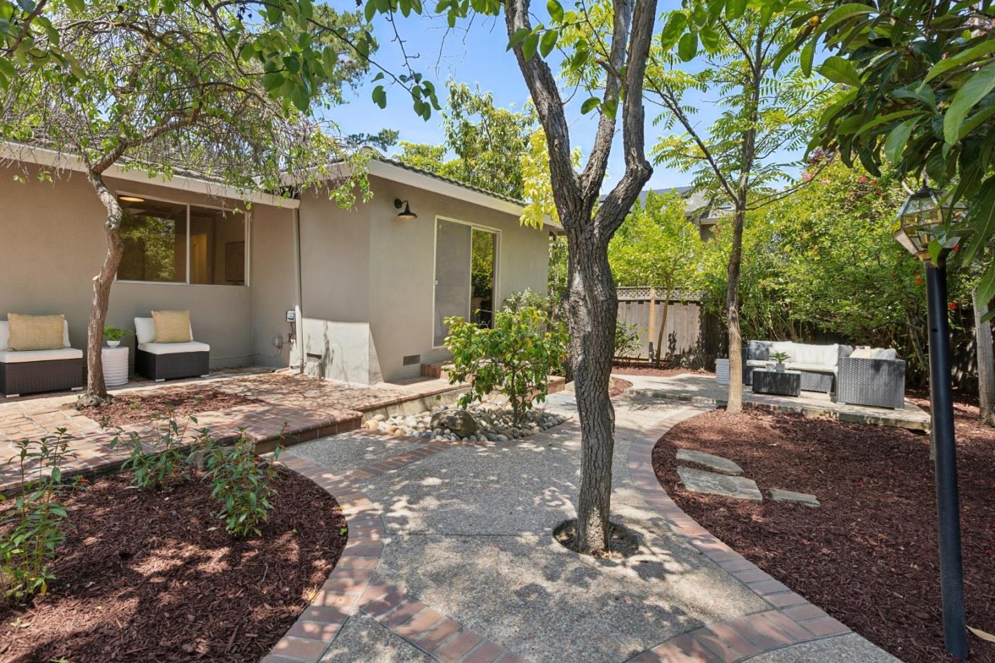 755 Santa Rita Avenue Los Altos, CA 94022 - Photo 46 of 50 a view of a backyard with table and chairs potted plants and large tree