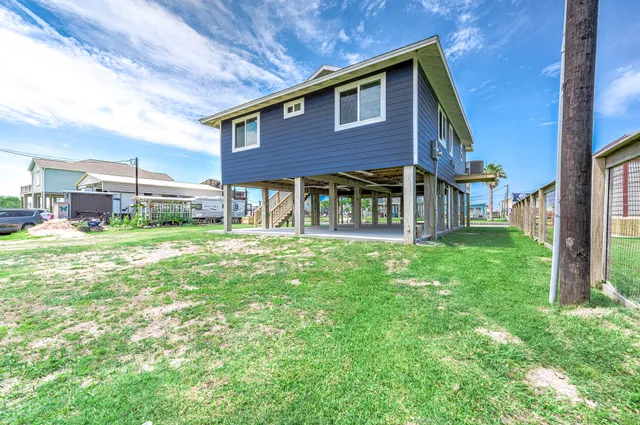 a red brick house with a big yard and large trees