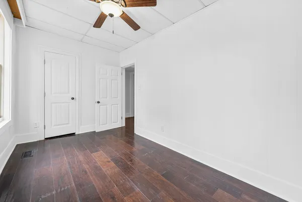 a view of a hallway with wooden floor and staircase