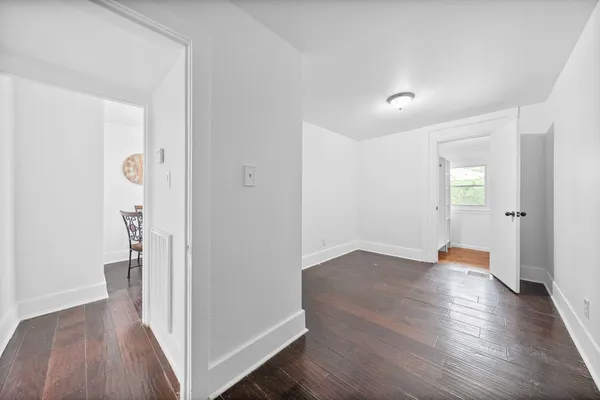 a kitchen with stainless steel appliances granite countertop a stove top oven a sink a dining table and chairs