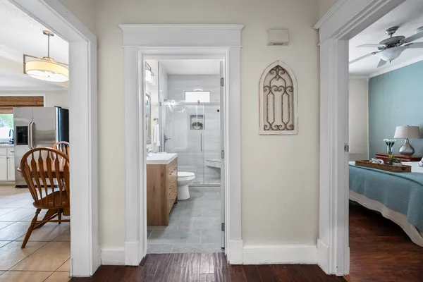 a kitchen with stainless steel appliances a refrigerator and wooden floor