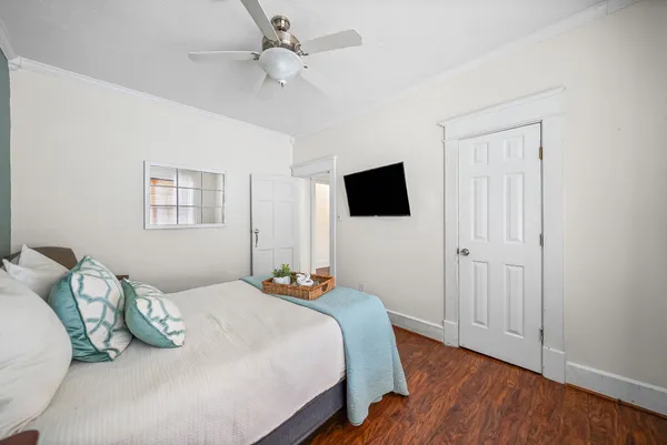 a view of a livingroom with wooden floor and a flat screen tv