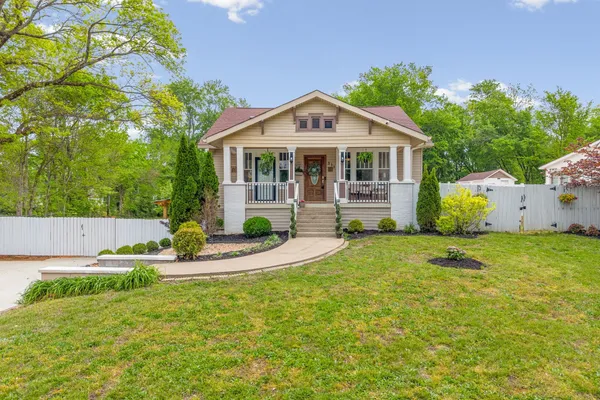 a view of a house with a yard patio and a garden