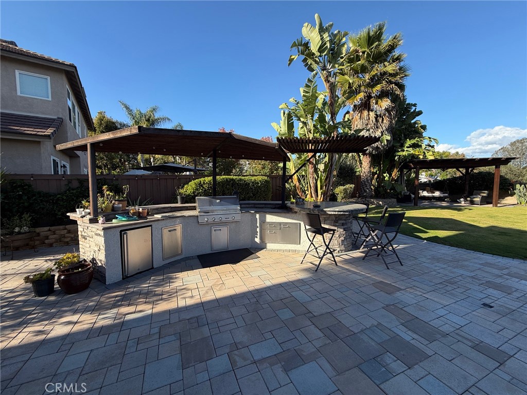 3918 Rill Court Carlsbad, CA 92010 - Photo 19 of 19 a view of a chairs and table in the patio and a fountain