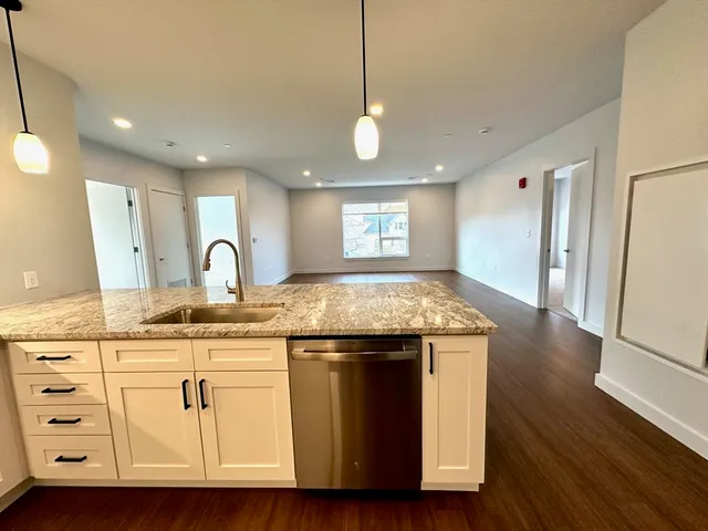 a kitchen with sink stove and refrigerator