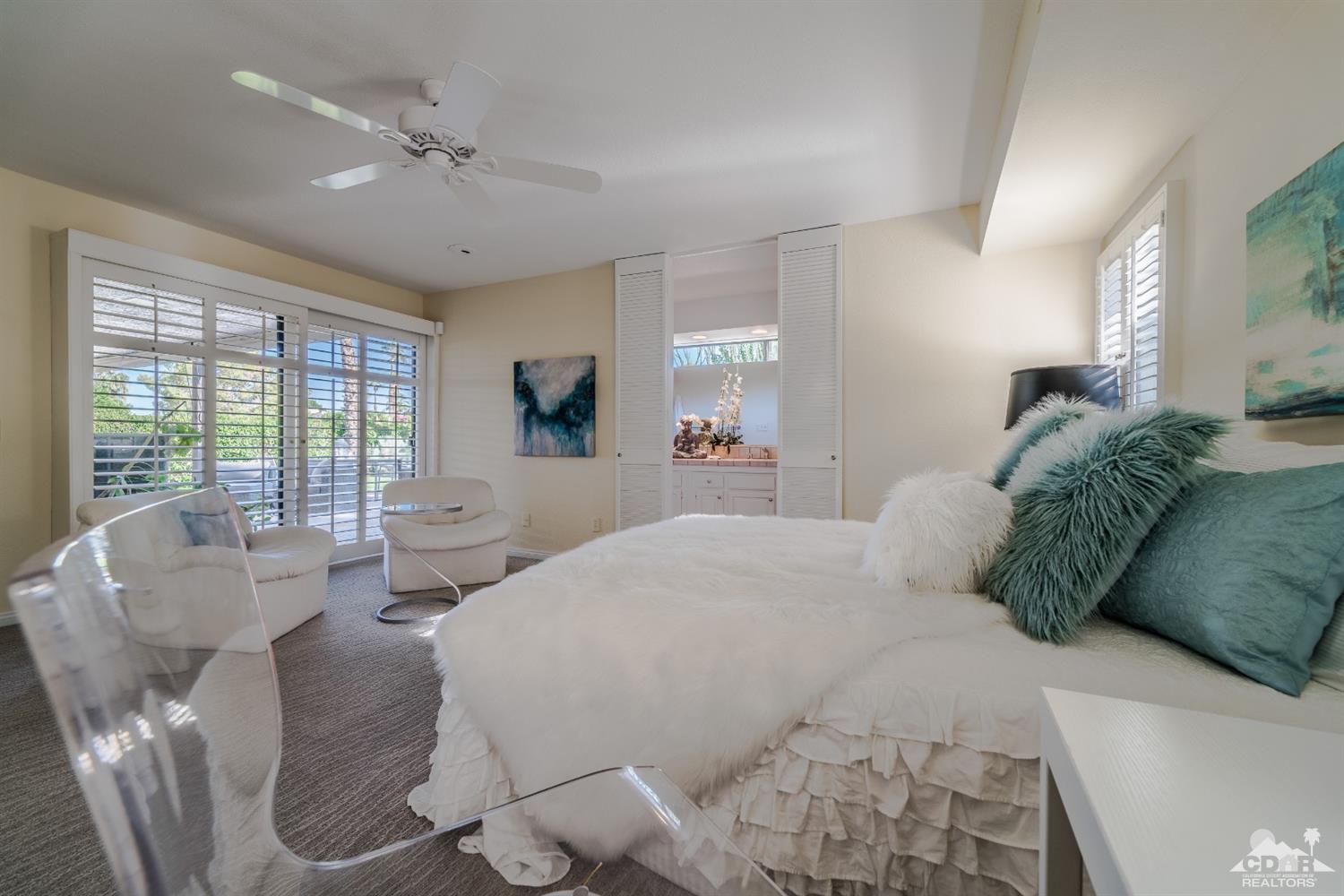 8 Kevin Lee Lane Rancho Mirage, CA 92270 - Photo 12 of 21 a spacious bedroom with a bed and glass windows