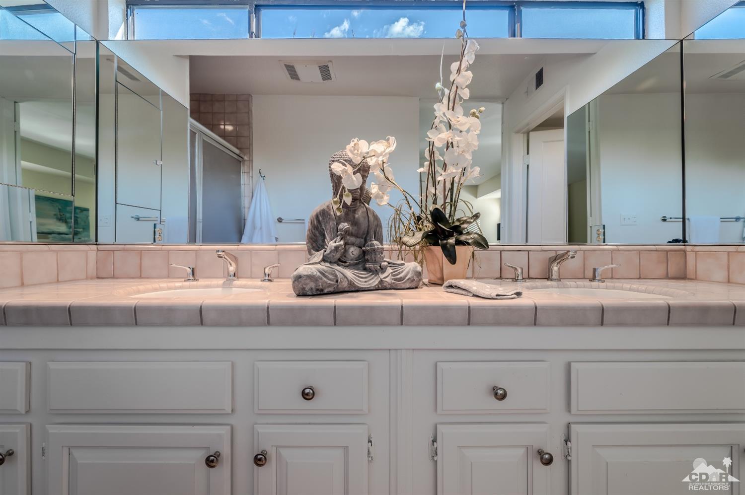 8 Kevin Lee Lane Rancho Mirage, CA 92270 - Photo 13 of 21 a bathroom with a sink vanity and a mirror
