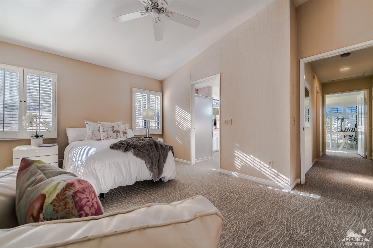 8 Kevin Lee Lane Rancho Mirage, CA 92270 - Photo 15 of 21 a bedroom with a bed and a chandelier