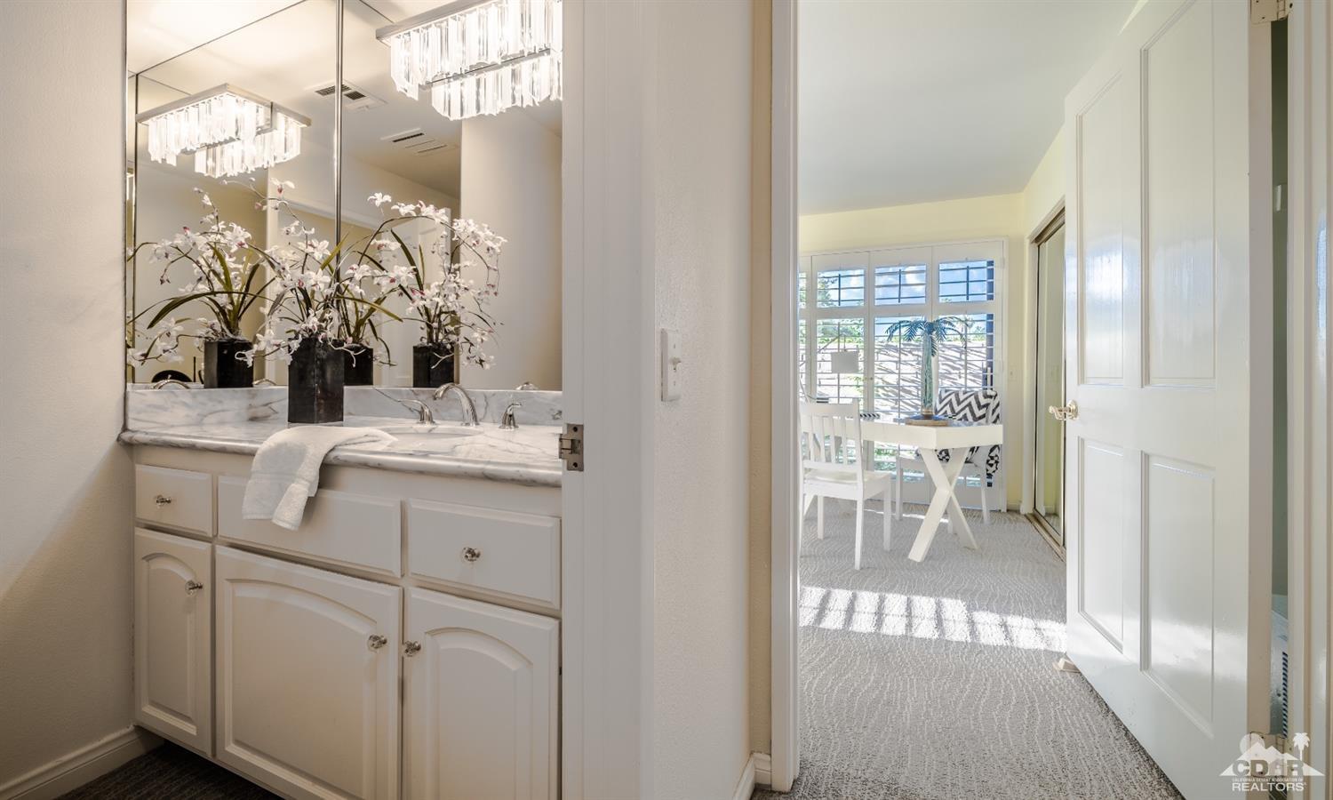 8 Kevin Lee Lane Rancho Mirage, CA 92270 - Photo 18 of 21 a bathroom with a sink vanity and a mirror