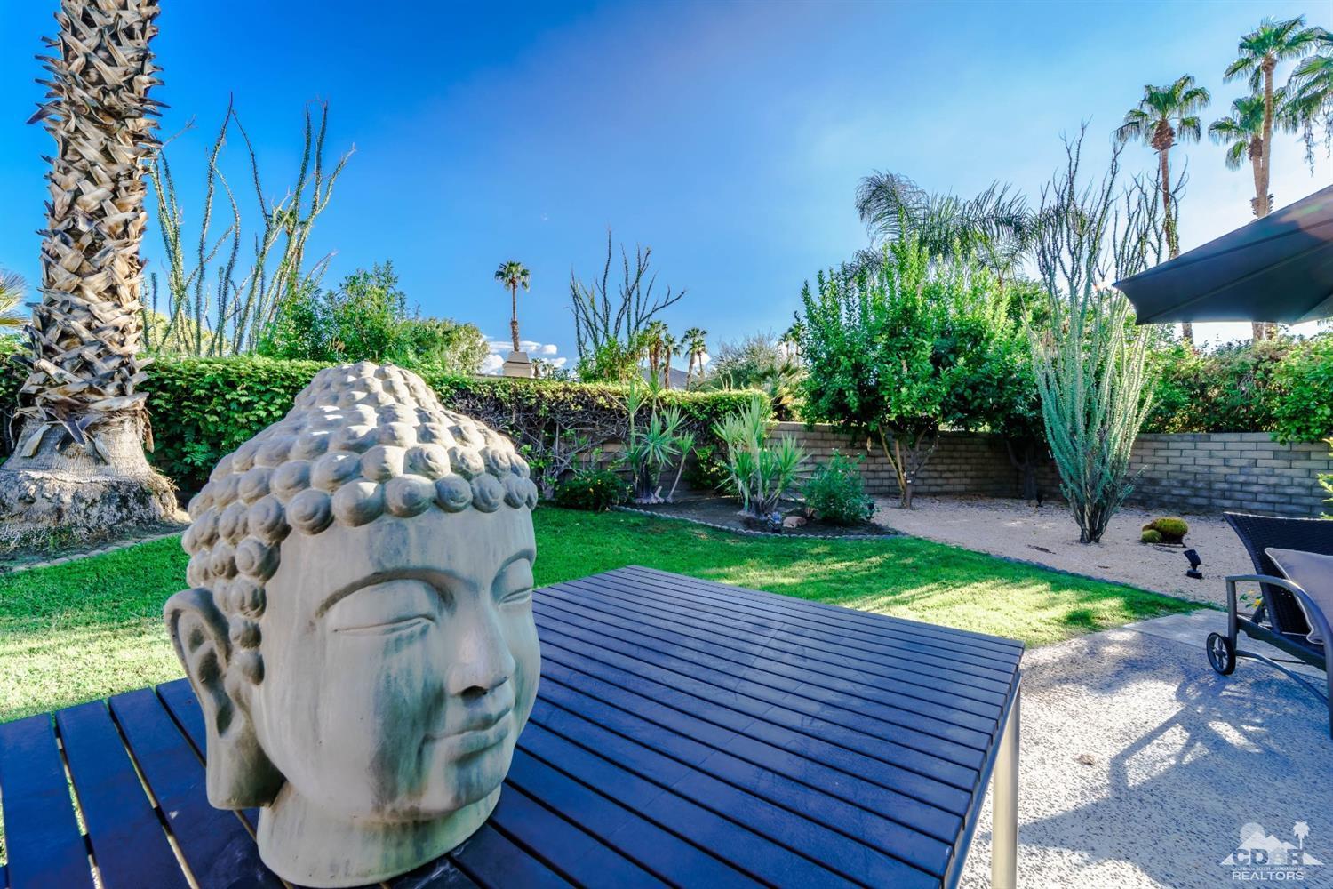 8 Kevin Lee Lane Rancho Mirage, CA 92270 - Photo 20 of 21 a backyard of a house with yard and outdoor seating