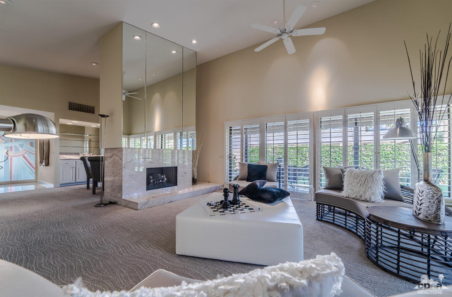 8 Kevin Lee Lane Rancho Mirage, CA 92270 - Photo 6 of 21 a living room with furniture a fireplace and a floor to ceiling window