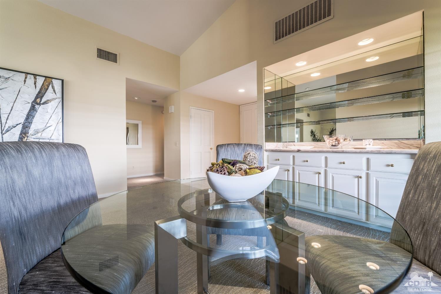 8 Kevin Lee Lane Rancho Mirage, CA 92270 - Photo 9 of 21 a large white kitchen with a sink and a large mirror
