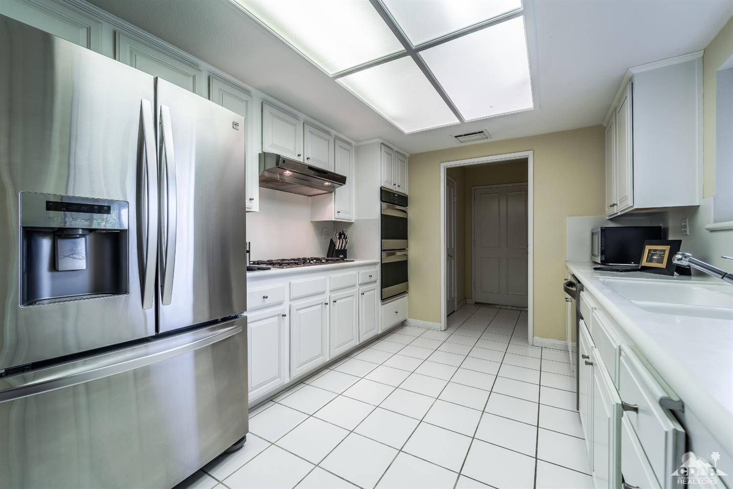 8 Kevin Lee Lane Rancho Mirage, CA 92270 - Photo 10 of 21 a kitchen with stainless steel appliances a refrigerator sink and microwave
