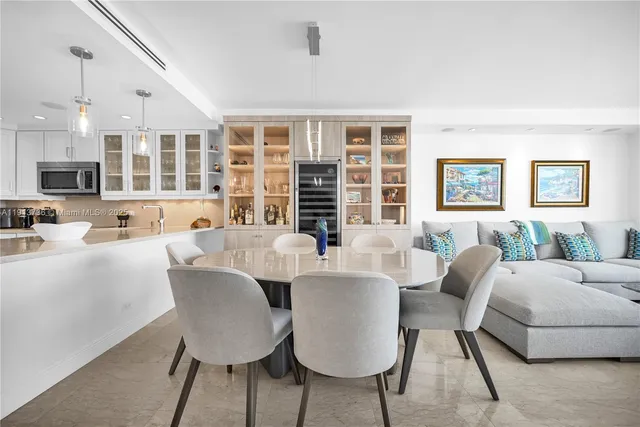 a view of a dining room with furniture a couch and chandelier