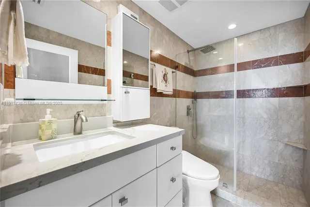 a bathroom with a sink toilet and shower