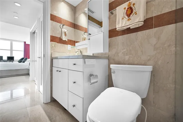 a white toilet sitting next to a bathroom sink