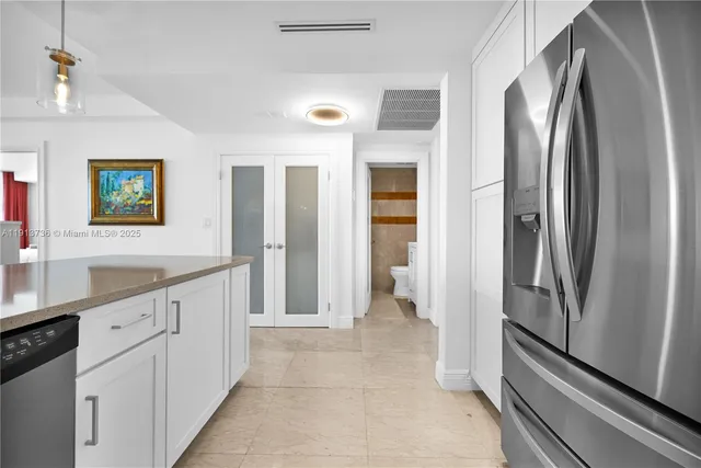 a kitchen with stainless steel appliances a refrigerator and a sink