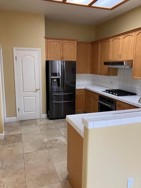 2157 West Rue St Michel Fresno, CA 93711 - Photo 8 of 22 a kitchen with a refrigerator and a sink