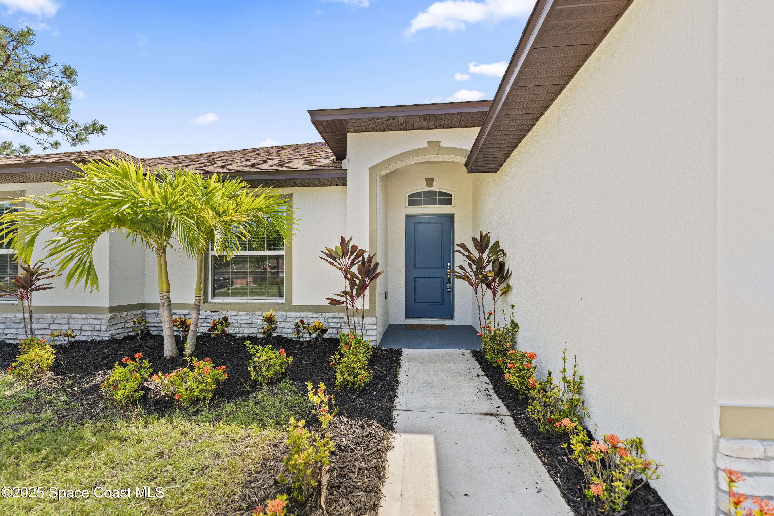 1938 Jupiter Boulevard Southwest Palm Bay, FL 32908 - Photo 1 of 21 a front view of a house with a garden