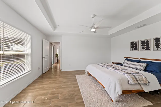 a bedroom with bed and window