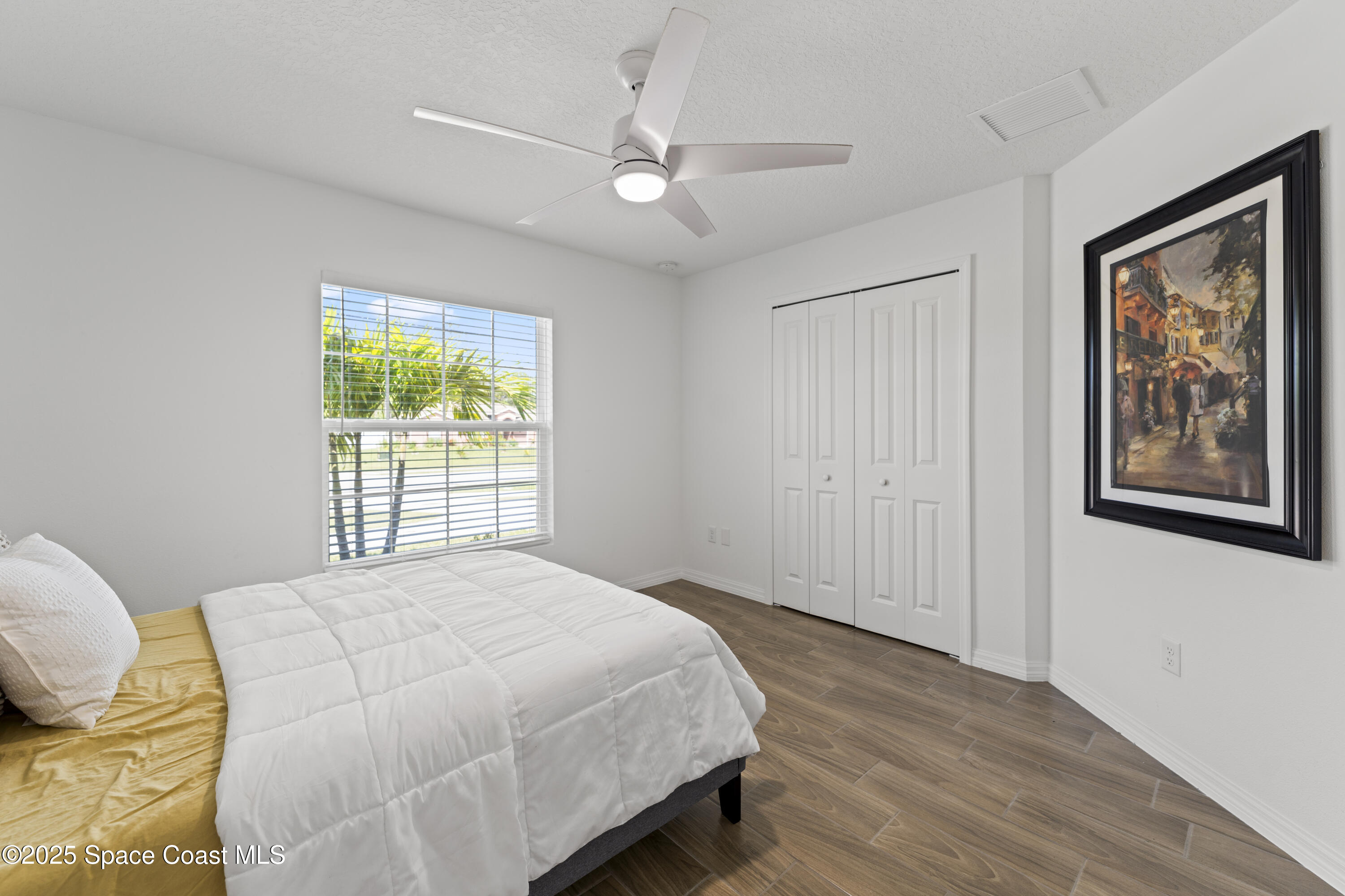 1938 Jupiter Boulevard Southwest Palm Bay, FL 32908 - Photo 15 of 21 a bedroom with a bed and a window