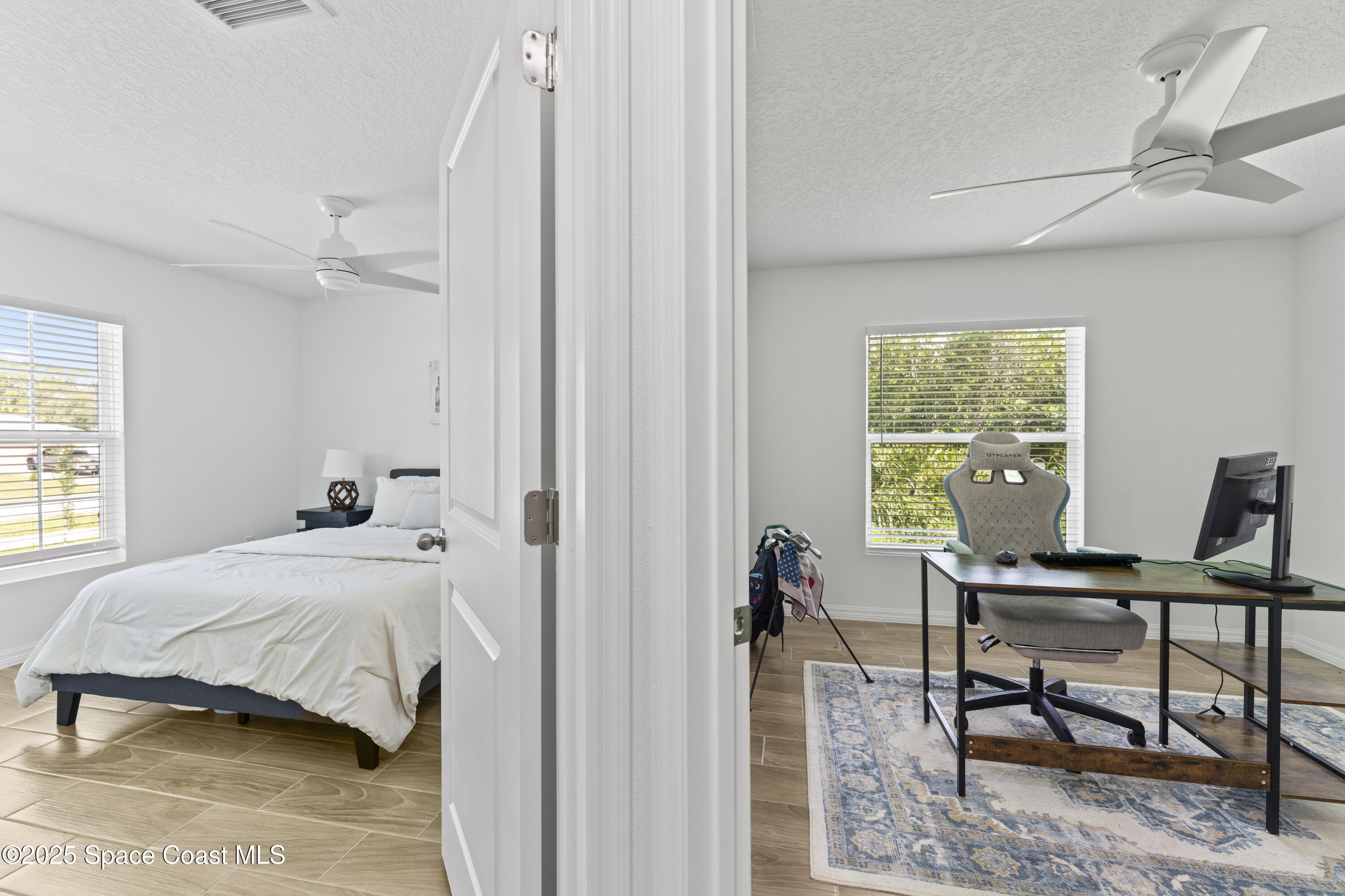 1938 Jupiter Boulevard Southwest Palm Bay, FL 32908 - Photo 16 of 21 a bedroom that has a bed and a table in it with window