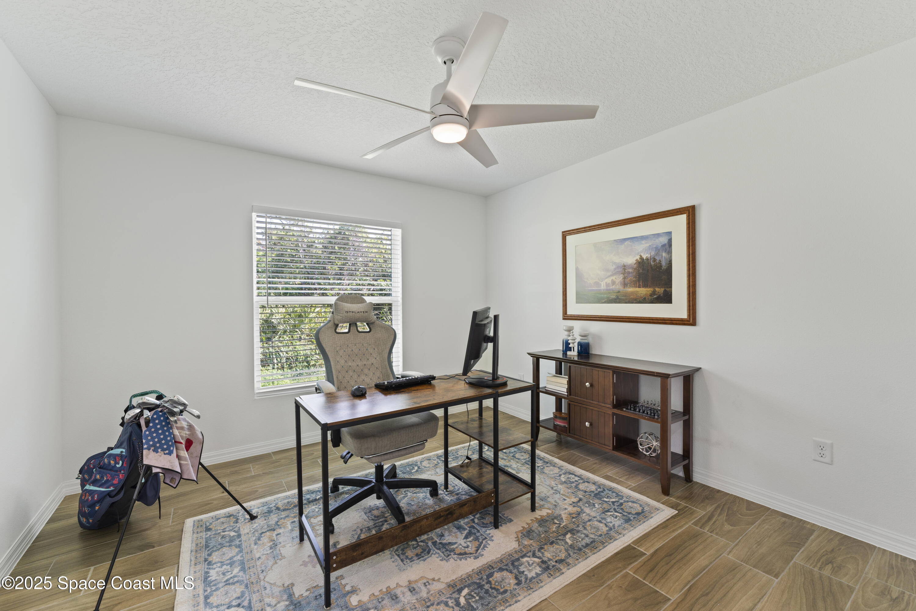 1938 Jupiter Boulevard Southwest Palm Bay, FL 32908 - Photo 17 of 21 a workspace with wooden floor and a rug