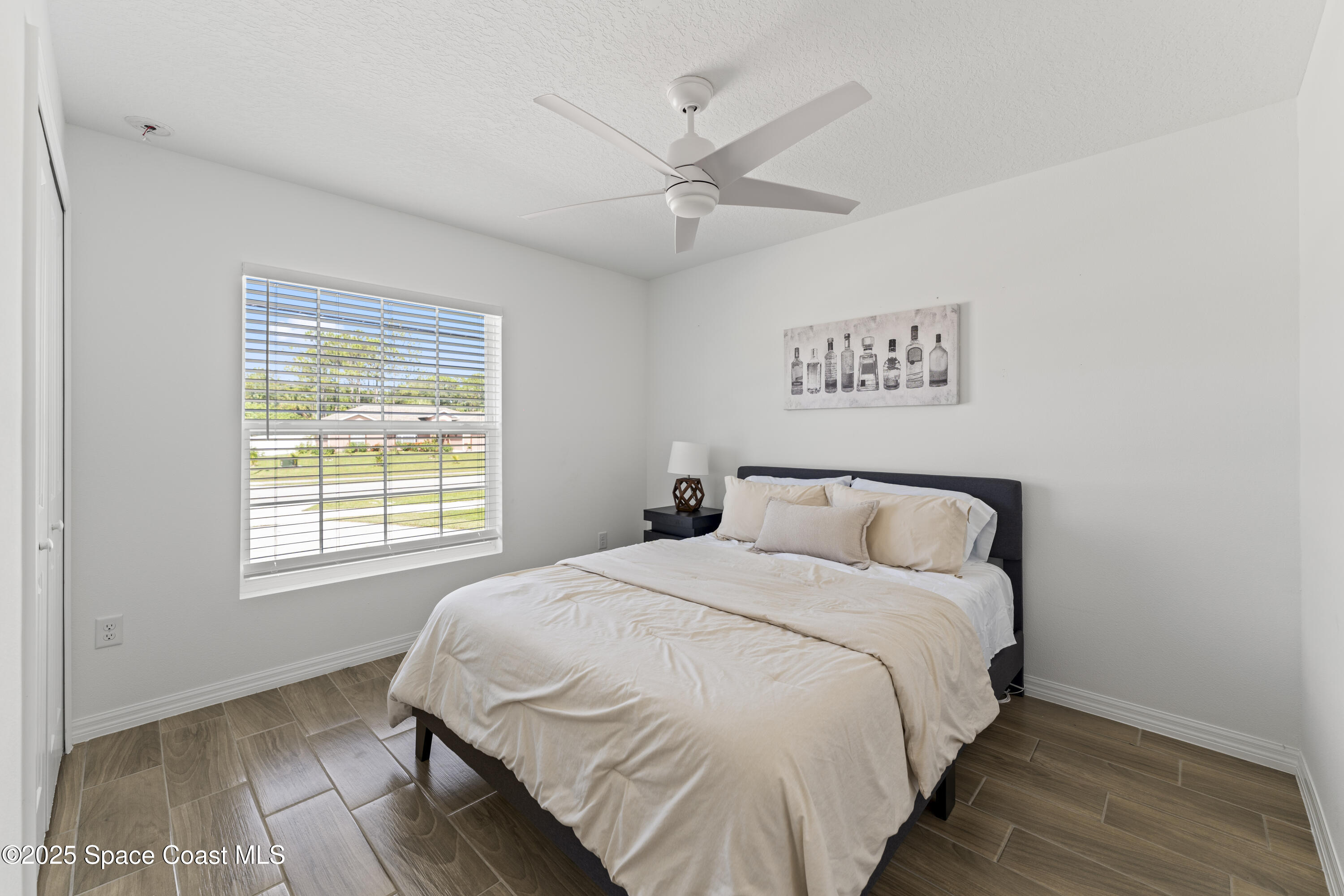 1938 Jupiter Boulevard Southwest Palm Bay, FL 32908 - Photo 18 of 21 a bedroom with a bed and a window
