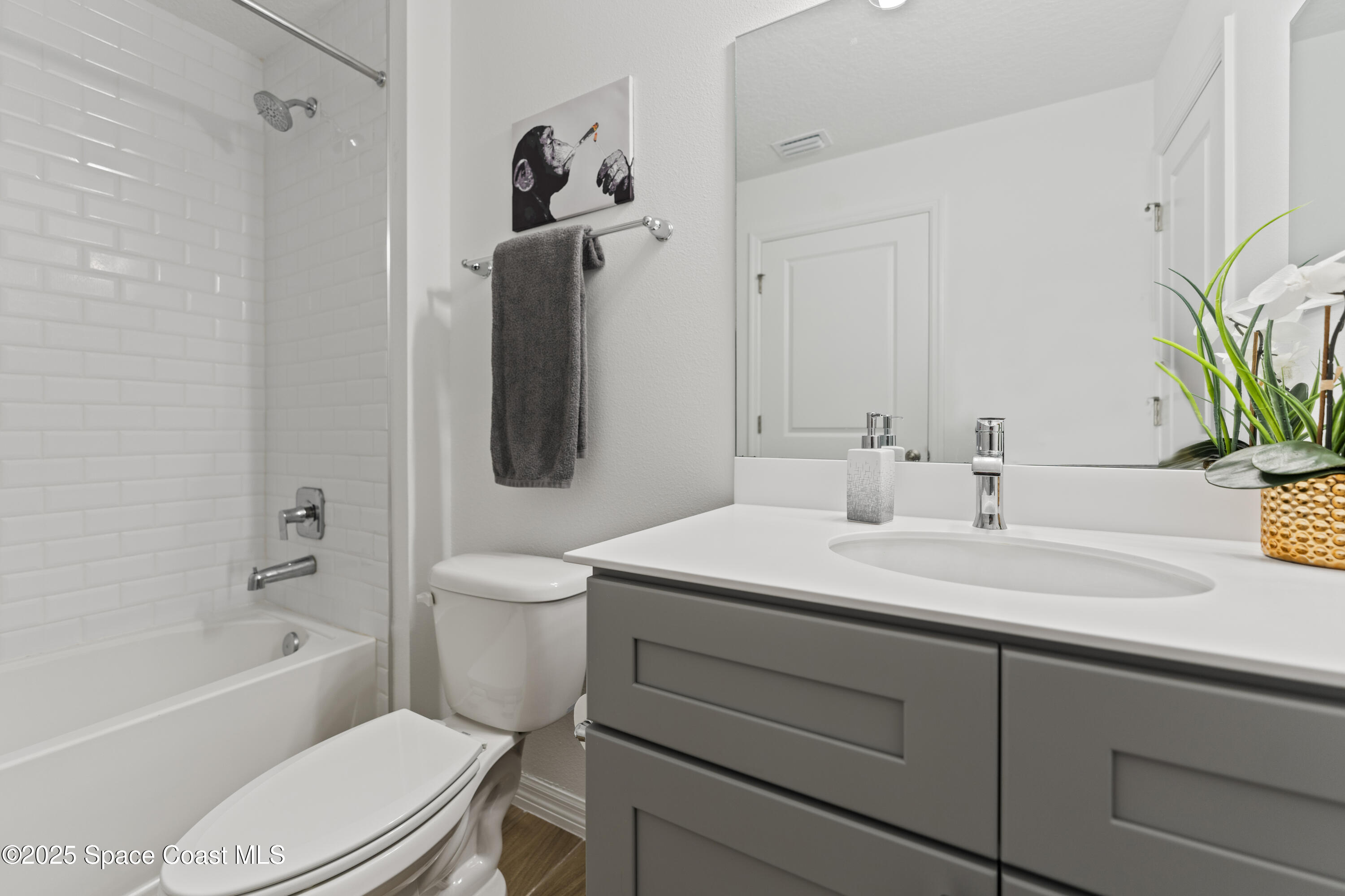 1938 Jupiter Boulevard Southwest Palm Bay, FL 32908 - Photo 19 of 21 a bathroom with a sink toilet and shower