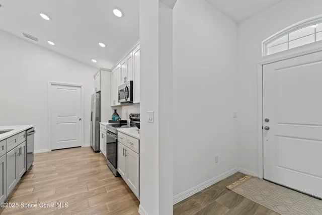 a view of a kitchen from the hallway