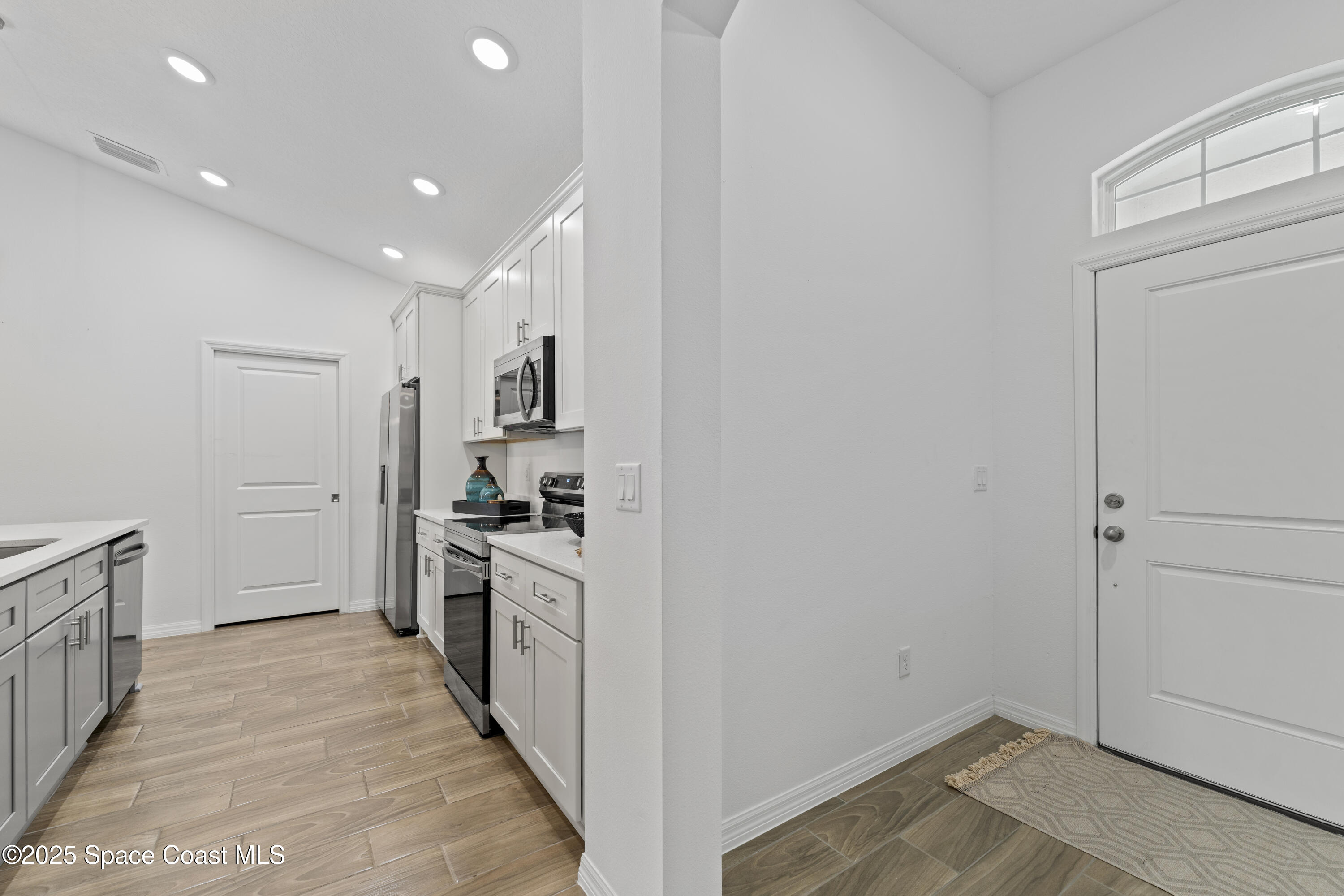 1938 Jupiter Boulevard Southwest Palm Bay, FL 32908 - Photo 4 of 21 a view of a kitchen from the hallway