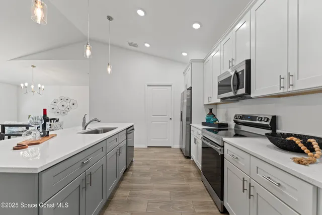 a kitchen with a sink stove and cabinets