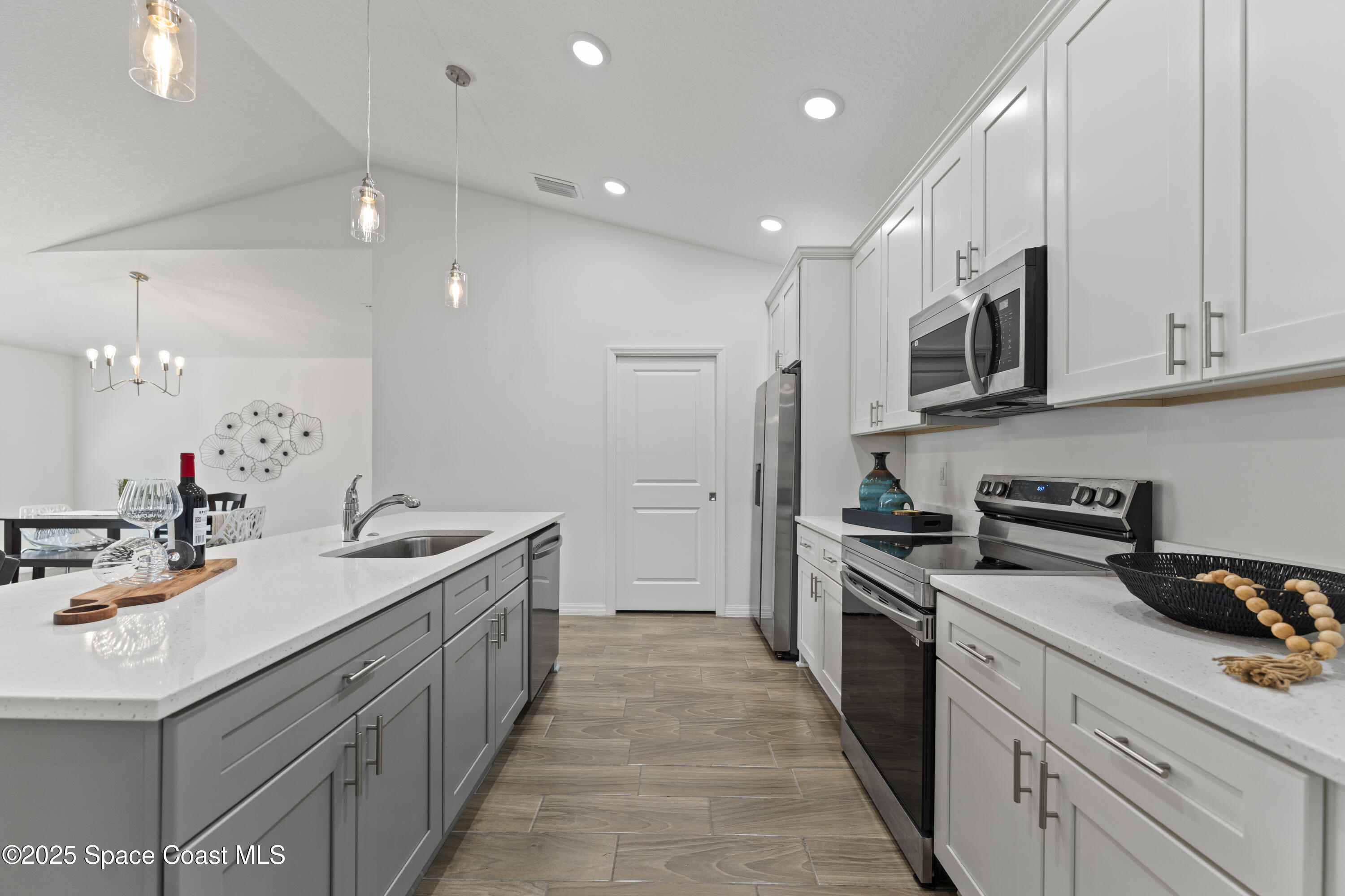 1938 Jupiter Boulevard Southwest Palm Bay, FL 32908 - Photo 6 of 21 a kitchen with a sink stove and cabinets