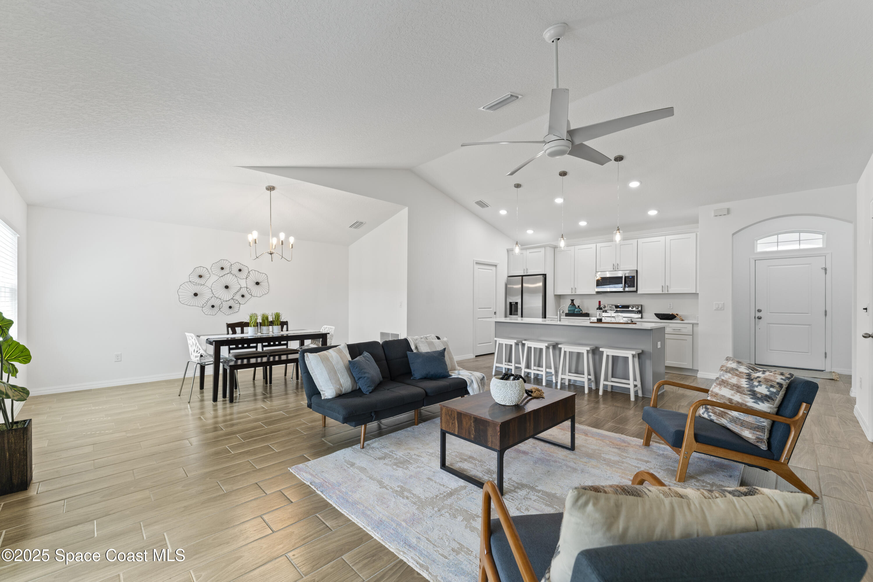 1938 Jupiter Boulevard Southwest Palm Bay, FL 32908 - Photo 8 of 21 a living room with furniture and kitchen view