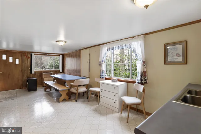 a living room with furniture a rug and gym equipment