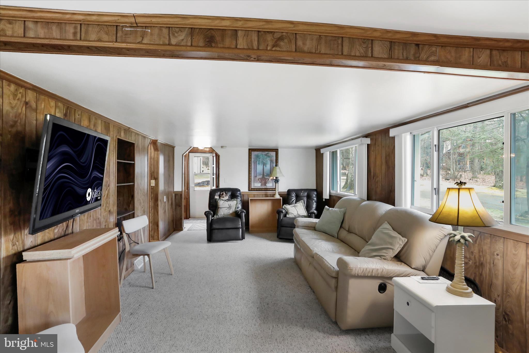 222 Skippers Point Road Oakland, MD 21550 - Photo 13 of 59 a living room with furniture a rug and gym equipment