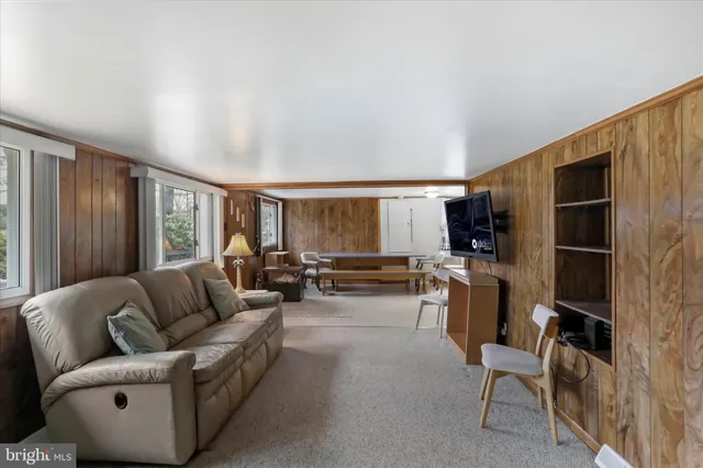 a bedroom with furniture and a large window