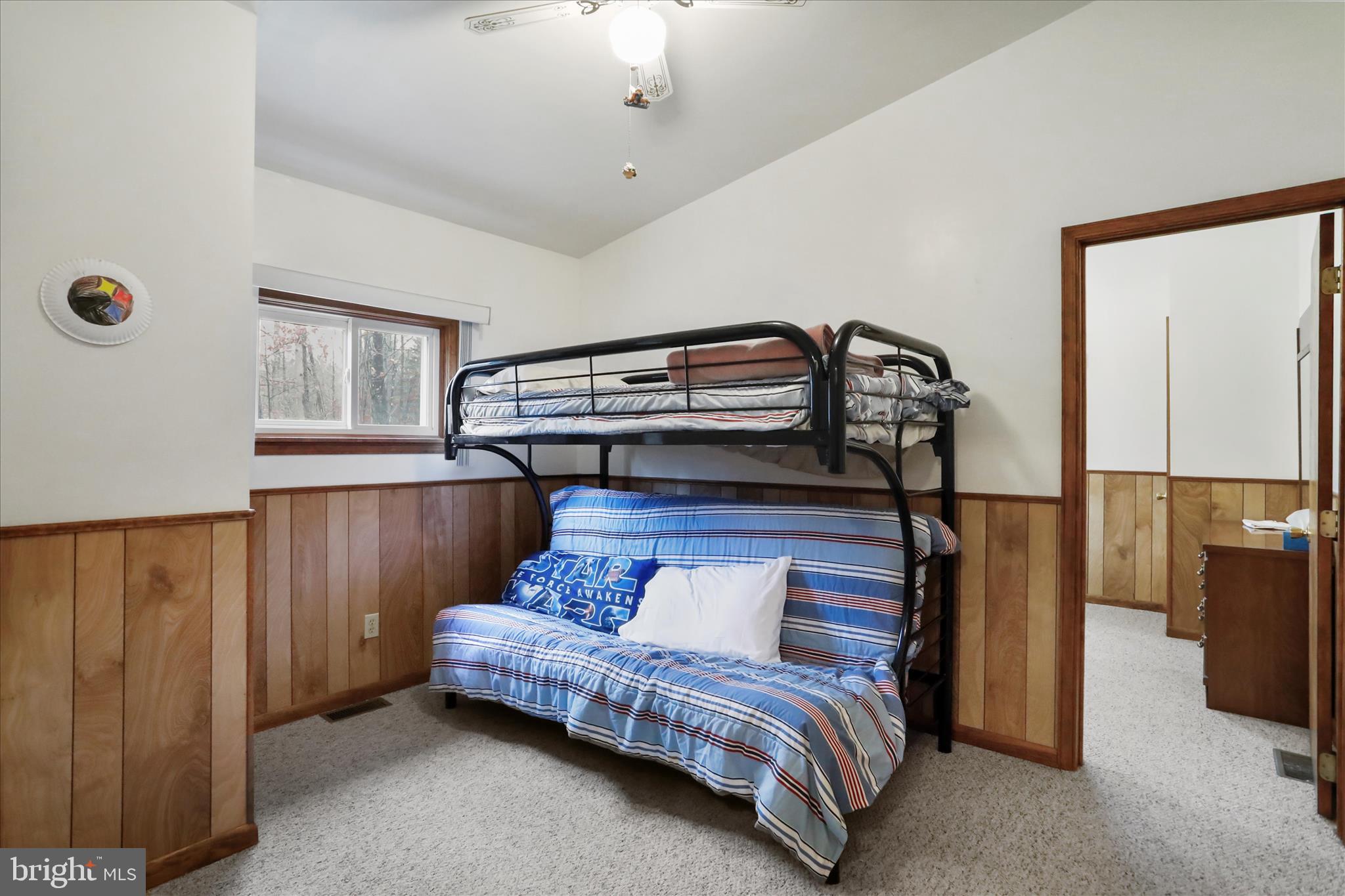 222 Skippers Point Road Oakland, MD 21550 - Photo 18 of 59 a bedroom with a bed and a chandelier