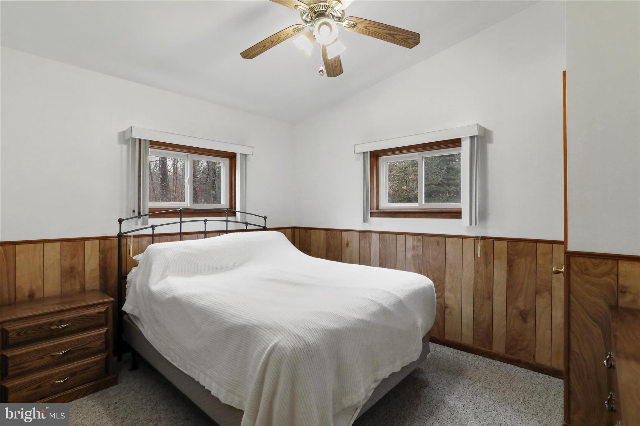 222 Skippers Point Road Oakland, MD 21550 - Photo 19 of 59 a bedroom with a bed and a chandelier