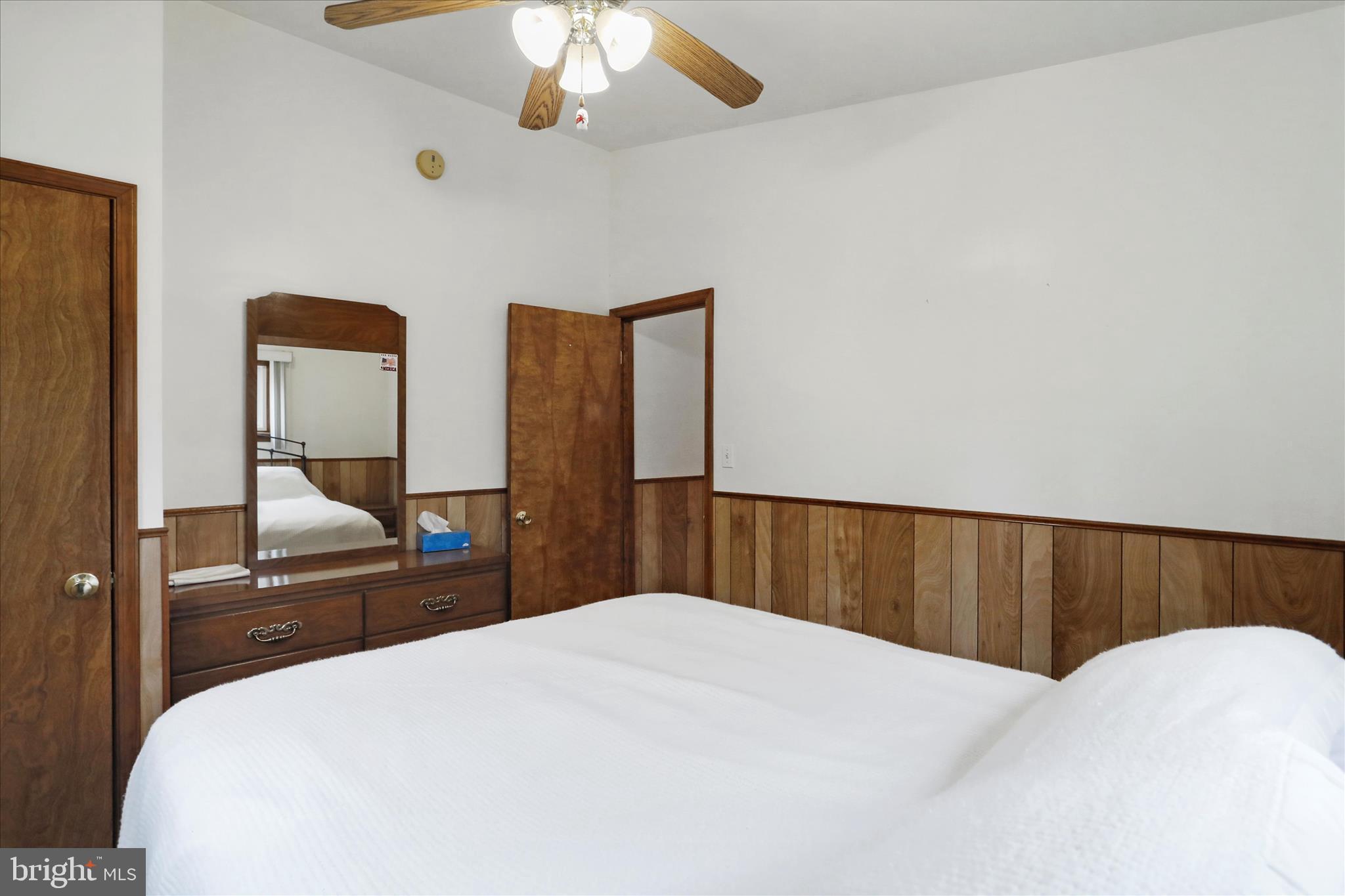 222 Skippers Point Road Oakland, MD 21550 - Photo 20 of 59 a bedroom with a bed and a chandelier